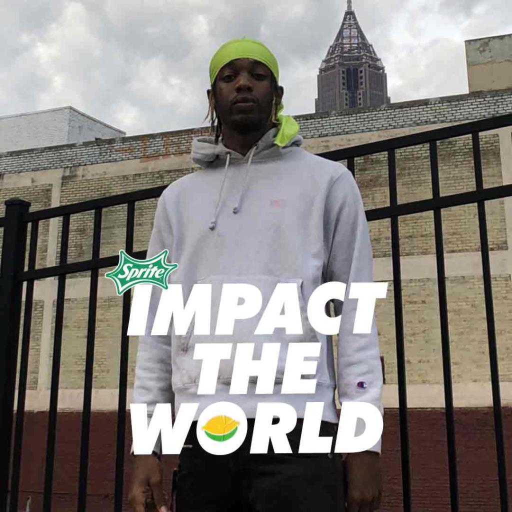 music artist in front of fence with text 'impact the world'